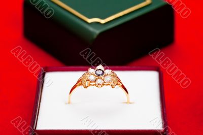 Gold ring with white and blue zirconia enchased