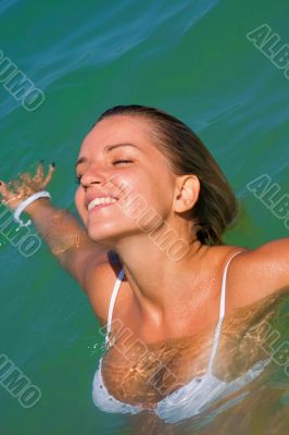 The sexual young girl swims in the sea
