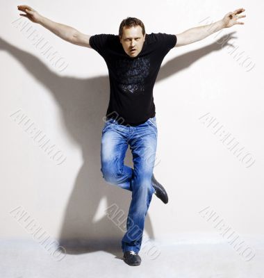 man in blue jeans and a black T-shirt