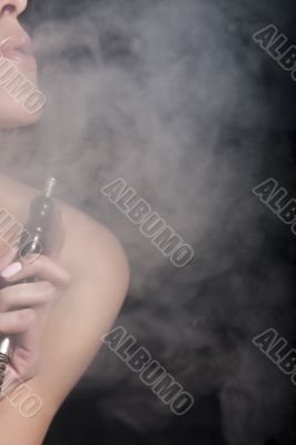 Woman smokes a hookah