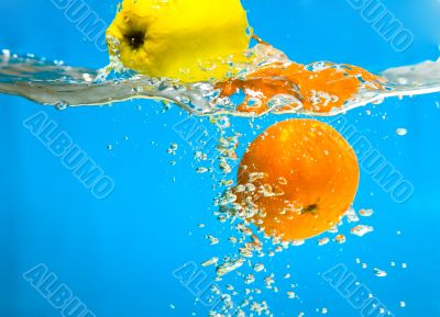 YELLOW APPLE AND CITRUS SPLASHING IN WATER 