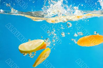 YELLOW citrus SPLASHING IN WATER 