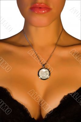 Women`s chest with a medallion