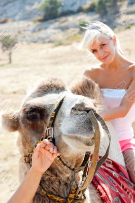 A girl riding a camel