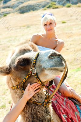 A girl riding a camel
