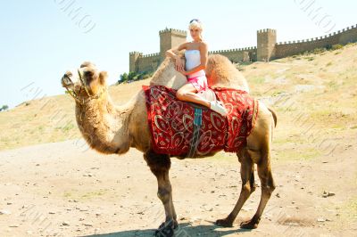 A girl riding a camel