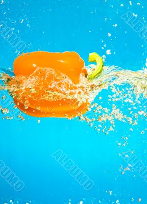 YELLOW PEPPER SPLASHING IN WATER 