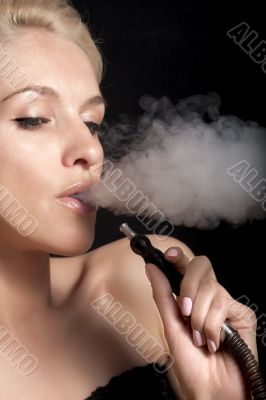 Woman smokes a hookah