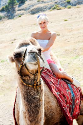 A girl riding a camel