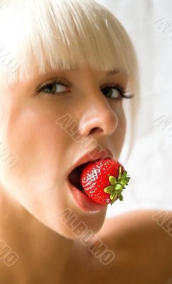 Woman eating a strawberry