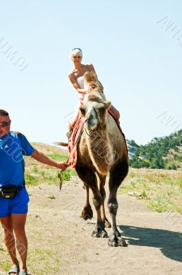 A girl riding a camel