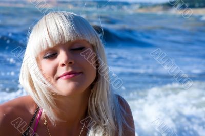 The beautiful blonde the girl against the sea