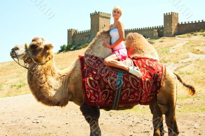 A girl riding a camel