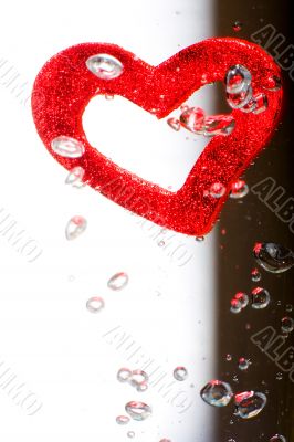 Valentine with red heart in water