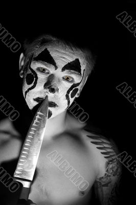 Evil clown with a knife