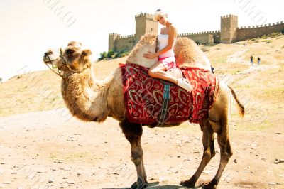 A girl riding a camel