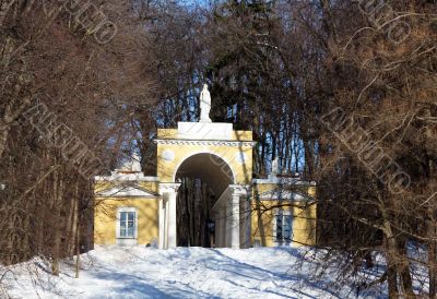 Structure with an arch among trees in winter