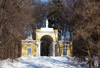 Structure with an arch among trees in winter