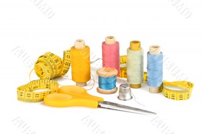 Thread, scissors, inch and a thimble