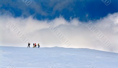 Four snowboarders go up the hill