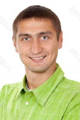 Portrait of a nice young guy in a green dress in studio on white