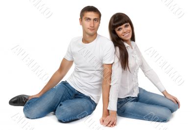 Romantic young couple sitting on floor