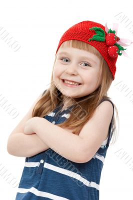 beautiful little girl in a red hat with a pattern of strawberrie