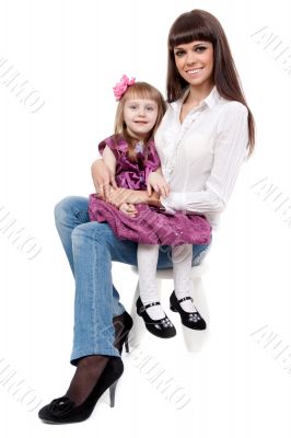 mother with a cute daughter sitting on a chair