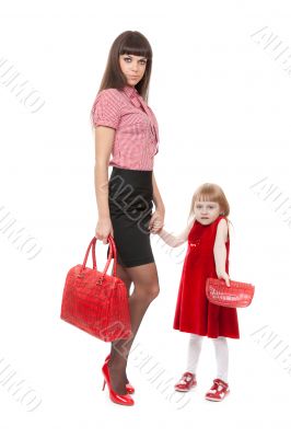 Fashionable Mom in red shoes and her little daughter with a beau
