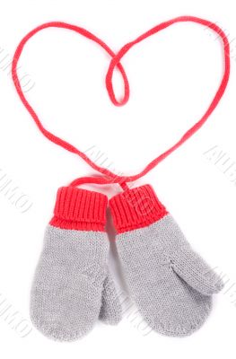 pair of gray baby mittens on a string in the form of heart