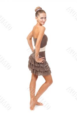 Portrait of the beautiful young girl in a beige dress with the l