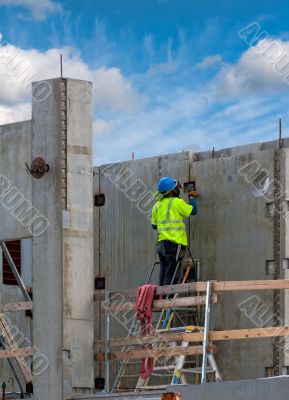 Working in a green jacket at a construction site