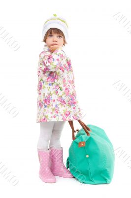 Pretty little girl in autumn clothes with a big bag. Studio port