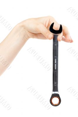 new wrench in female hand. 