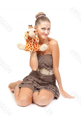 Portrait of beautiful girl sitting on the floor in the studio wi