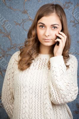 portrait of a girl with a telephone against the backdrop of a re