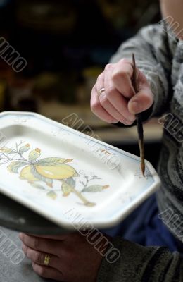 Hand holding paintbrush