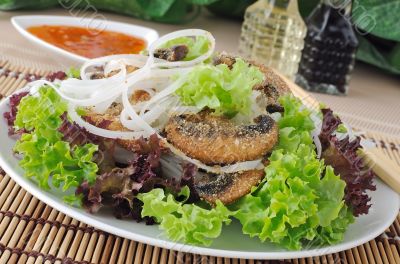 Rice noodles with mushrooms in breadcrumbs in lettuce leaves