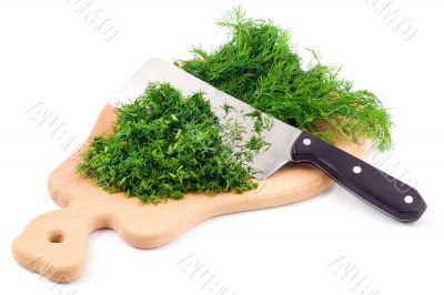 Cutting fresh dill on a cutting board