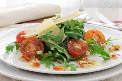 salad of arugula and cherry tomatoes with parmesan sauce