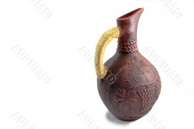Ceramic jug for wine from red clay on a white background