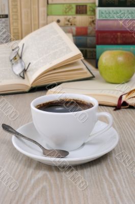 A cup of fragrant black coffee on the table against the backgrou