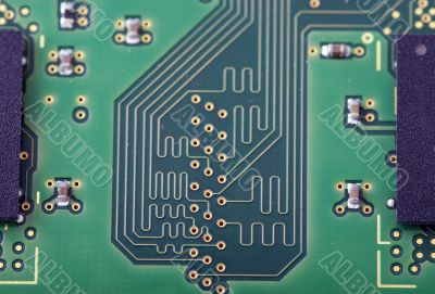 Green computer board with chips and components. 