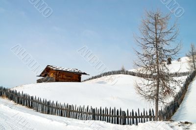 Old winter cottage with fence