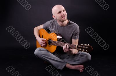 Nice bald guy with a guitar