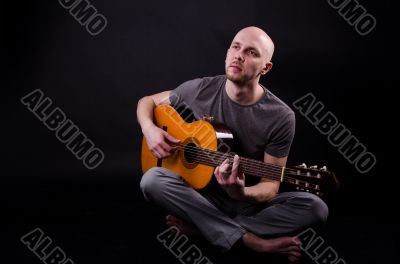 Nice bald guy with a guitar