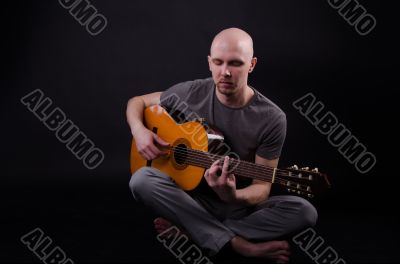 Nice bald guy with a guitar