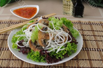 Rice noodles with mushrooms in breadcrumbs in lettuce leaves