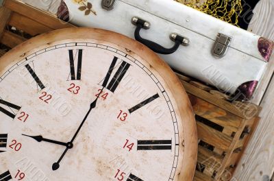 Vintage white suitcase on the box with clock