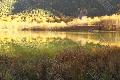 An autumn lake is in mountains